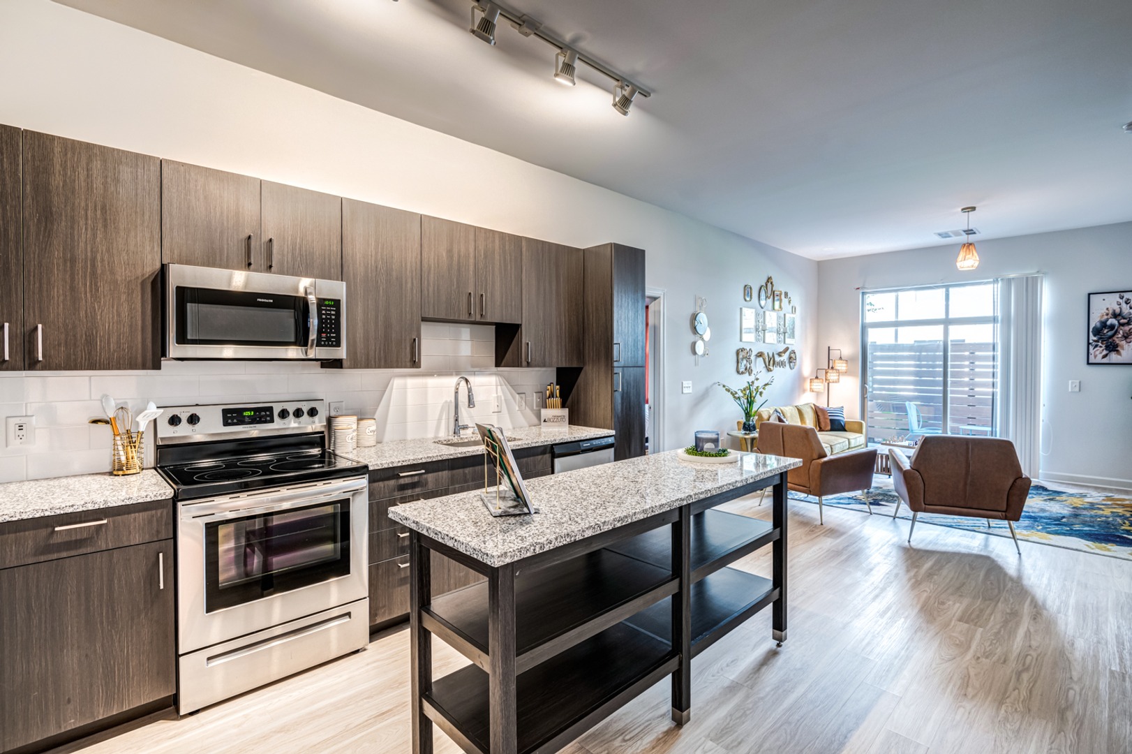 Kitchen with island and view of living room